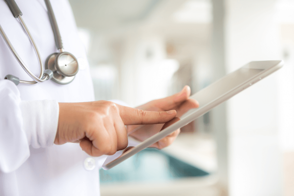 Clinician reviewing notes on a ward round